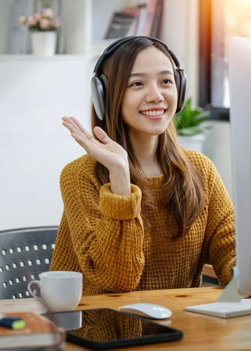 young-beautiful-asian-woman-with-headphone-sitting-at-home-office-video-call-event-with-clients-